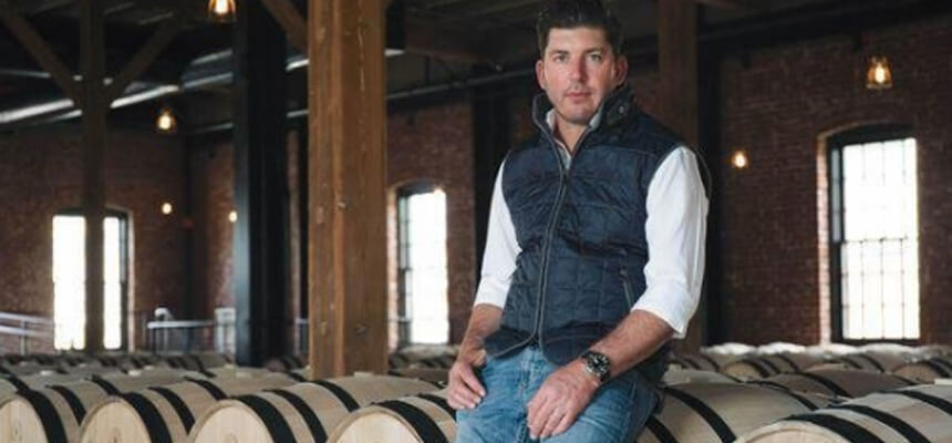 Dave Phinney sitting on a wine barrel